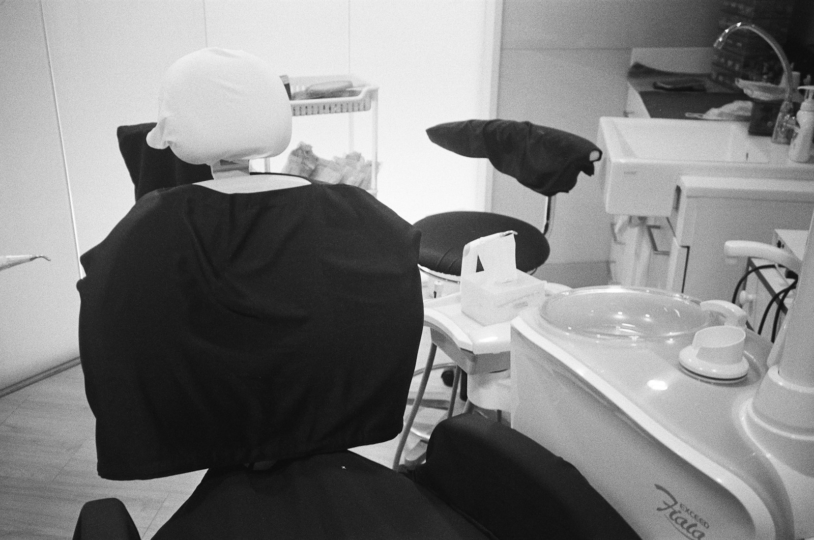 Empty dental clinic treatment room with dental chair and equipment