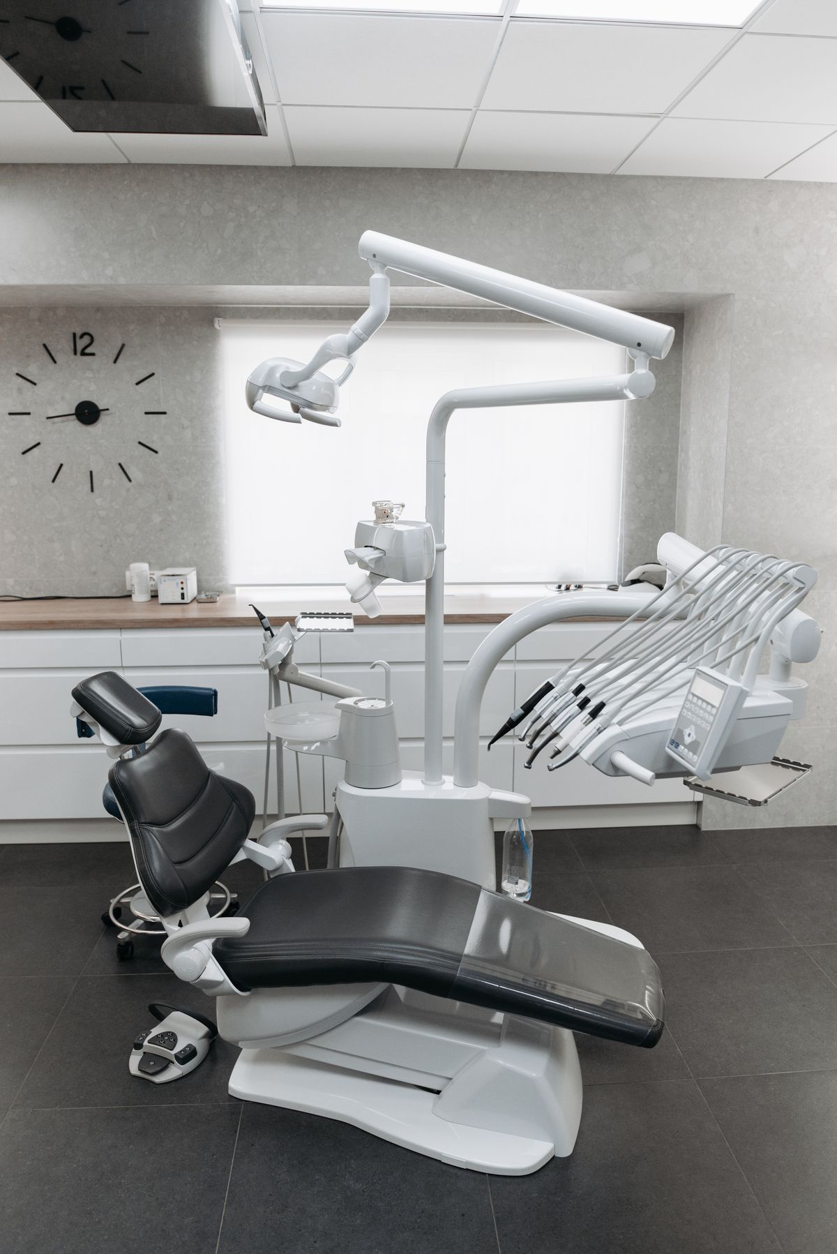 Bright empty dental treatment room with chair and equipment