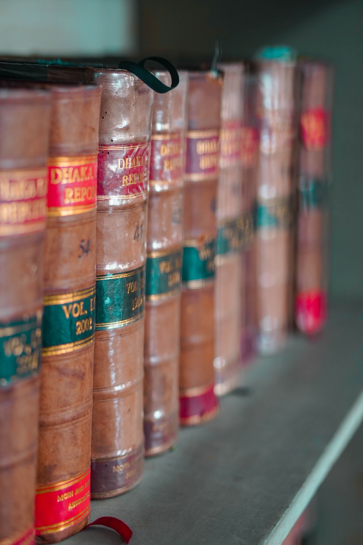 Close-up of leather-bound legal reference books on a shelf